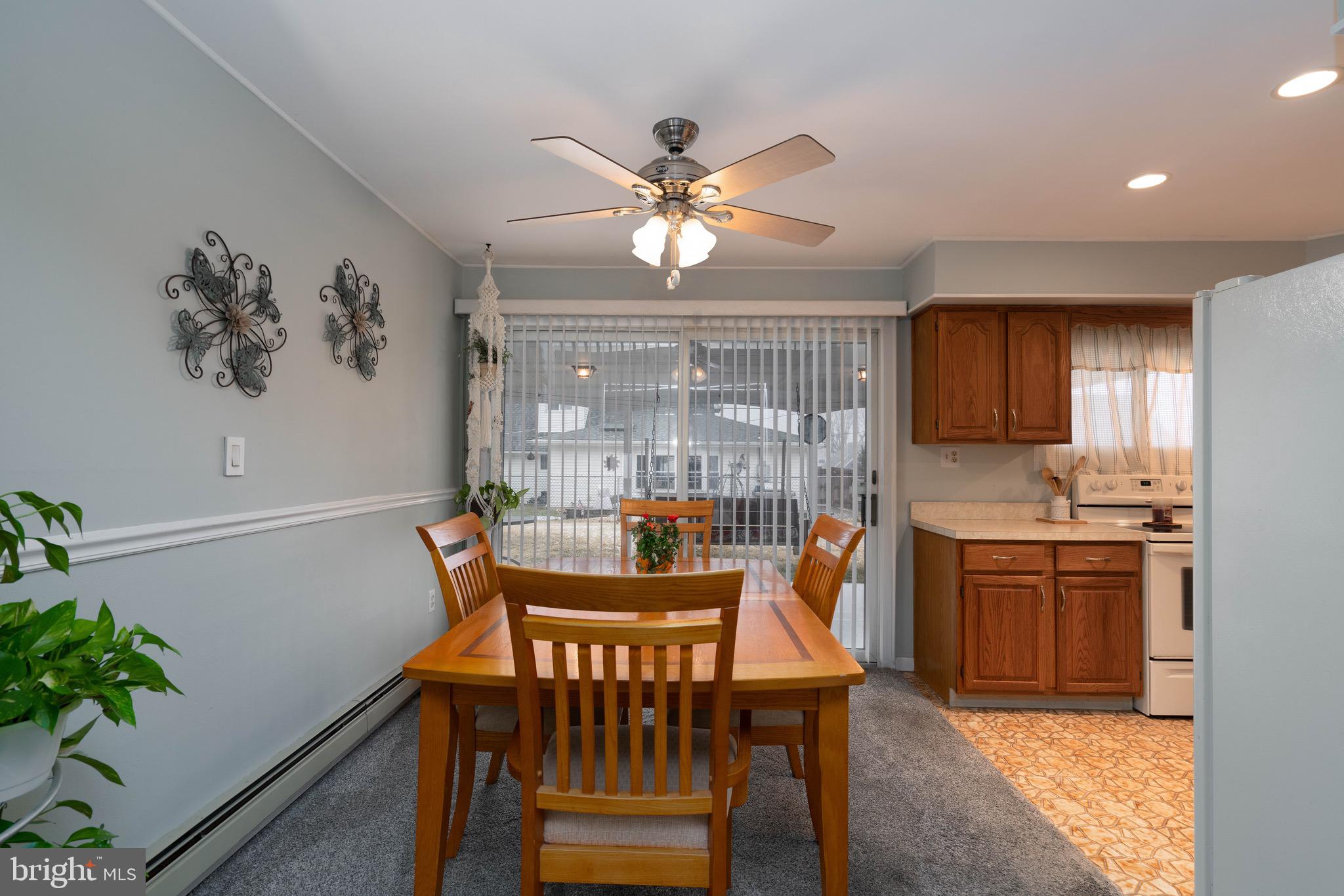 14 Tinder Road Levittown, PA 19056 - Photo 8 of 30 a dining room with furniture a chandelier and wooden floor