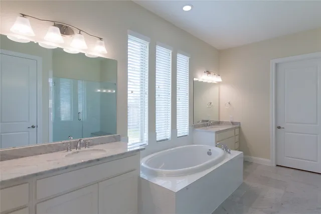 a bathroom with a bathtub and shower