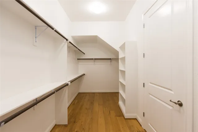 a view of hallway with wooden floor