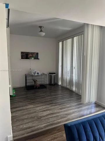 a view of water heater room with wooden floor