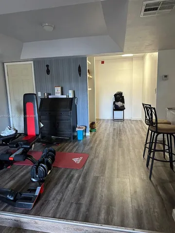 a bedroom with furniture and a air conditioner vent