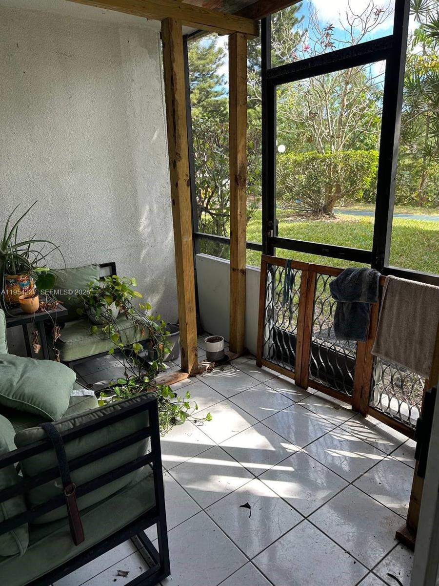 3720 Inverrary Drive, Unit 1L Lauderhill, FL 33319 - Photo 19 of 20 a living room with furniture and a potted plant