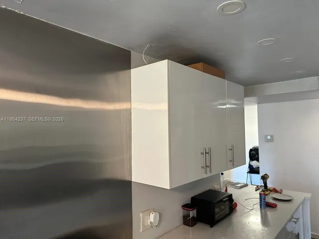 a kitchen with a sink and cabinets