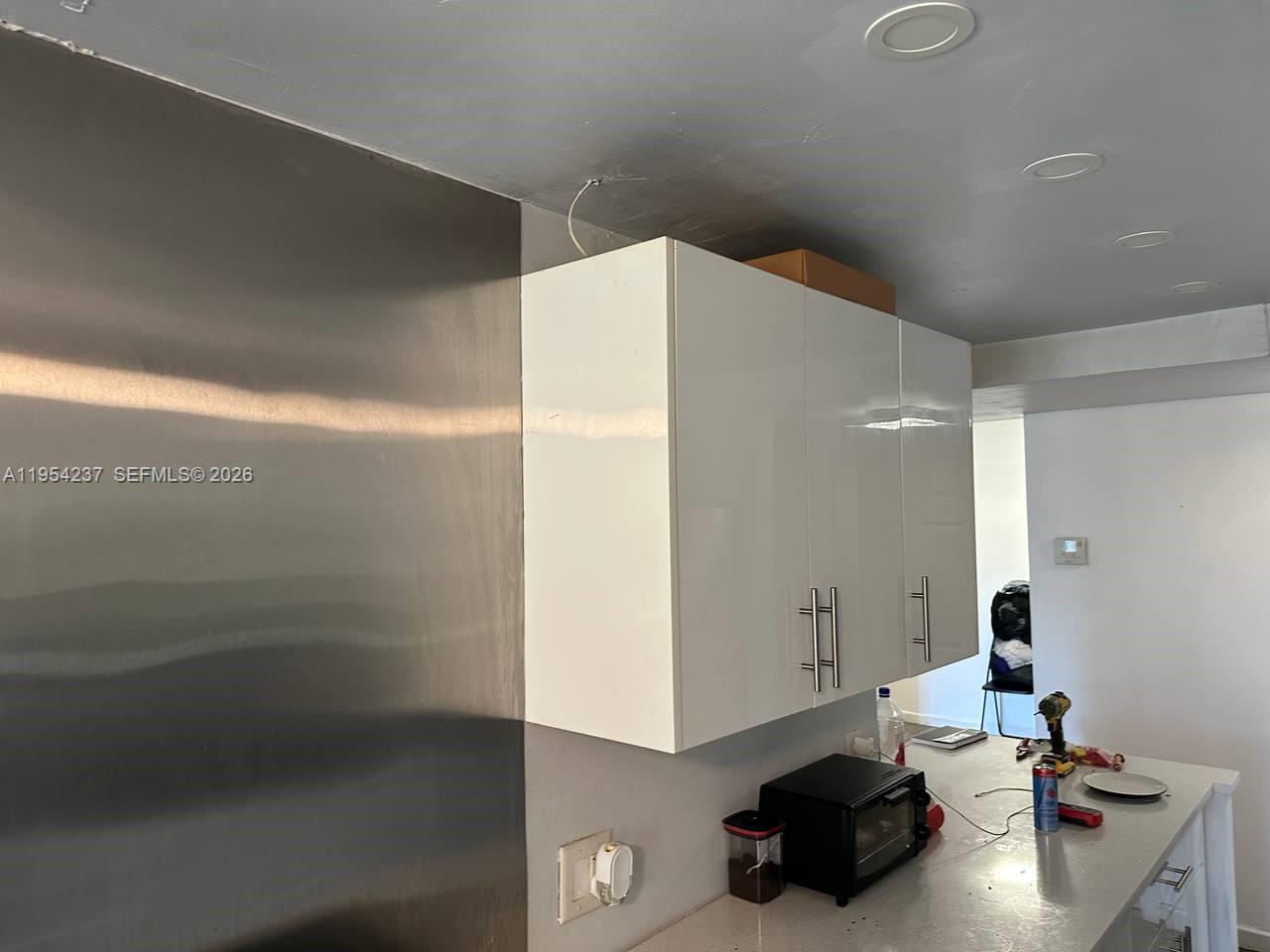 3720 Inverrary Drive, Unit 1L Lauderhill, FL 33319 - Photo 2 of 20 a kitchen with a sink and cabinets