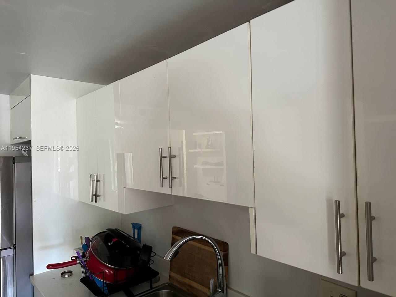 3720 Inverrary Drive, Unit 1L Lauderhill, FL 33319 - Photo 3 of 20 a kitchen with cabinets and window