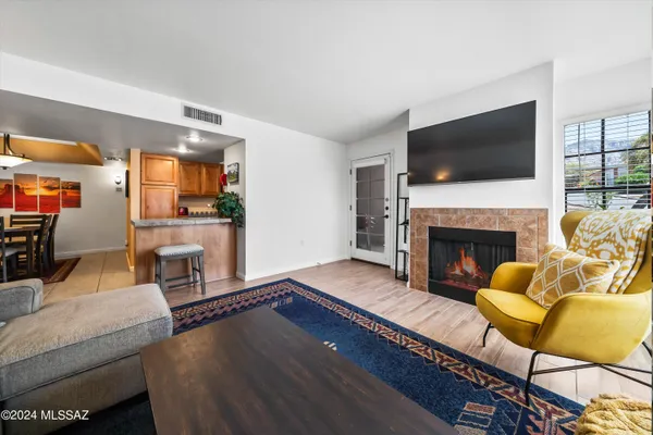 a living room with furniture fireplace and flat screen tv