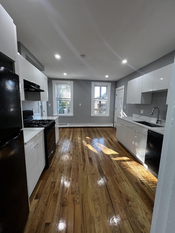 5 Sunset Street, Unit 2 Boston, MA 02120 - Photo 2 of 11 a kitchen with granite countertop lots of counter top space and stainless steel appliances