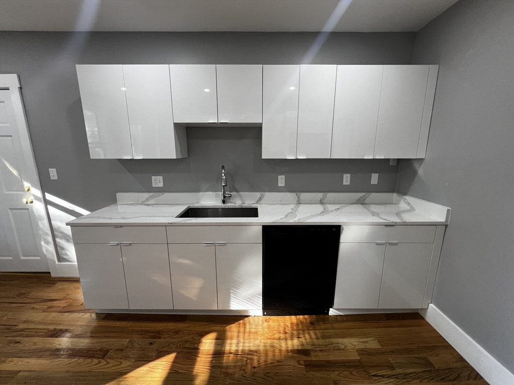 5 Sunset Street, Unit 2 Boston, MA 02120 - Photo 3 of 11 a kitchen with a sink and cabinets
