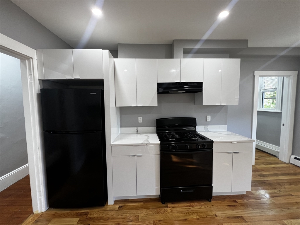 5 Sunset Street, Unit 2 Boston, MA 02120 - Photo 4 of 11 a kitchen with a sink a stove and refrigerator
