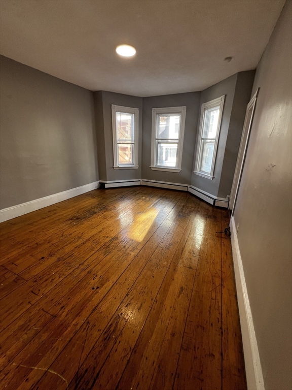 5 Sunset Street, Unit 2 Boston, MA 02120 - Photo 6 of 11 a view of empty room with wooden floor and fan