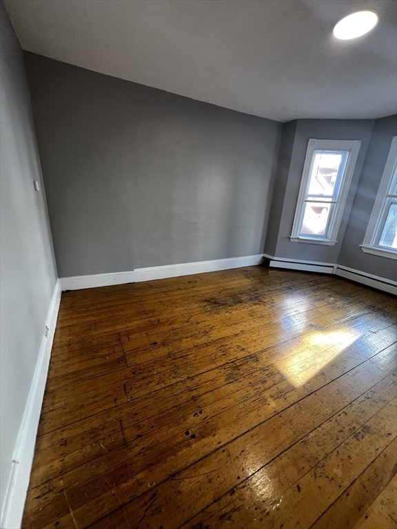 5 Sunset Street, Unit 2 Boston, MA 02120 - Photo 7 of 11 wooden floor in an empty room with a window