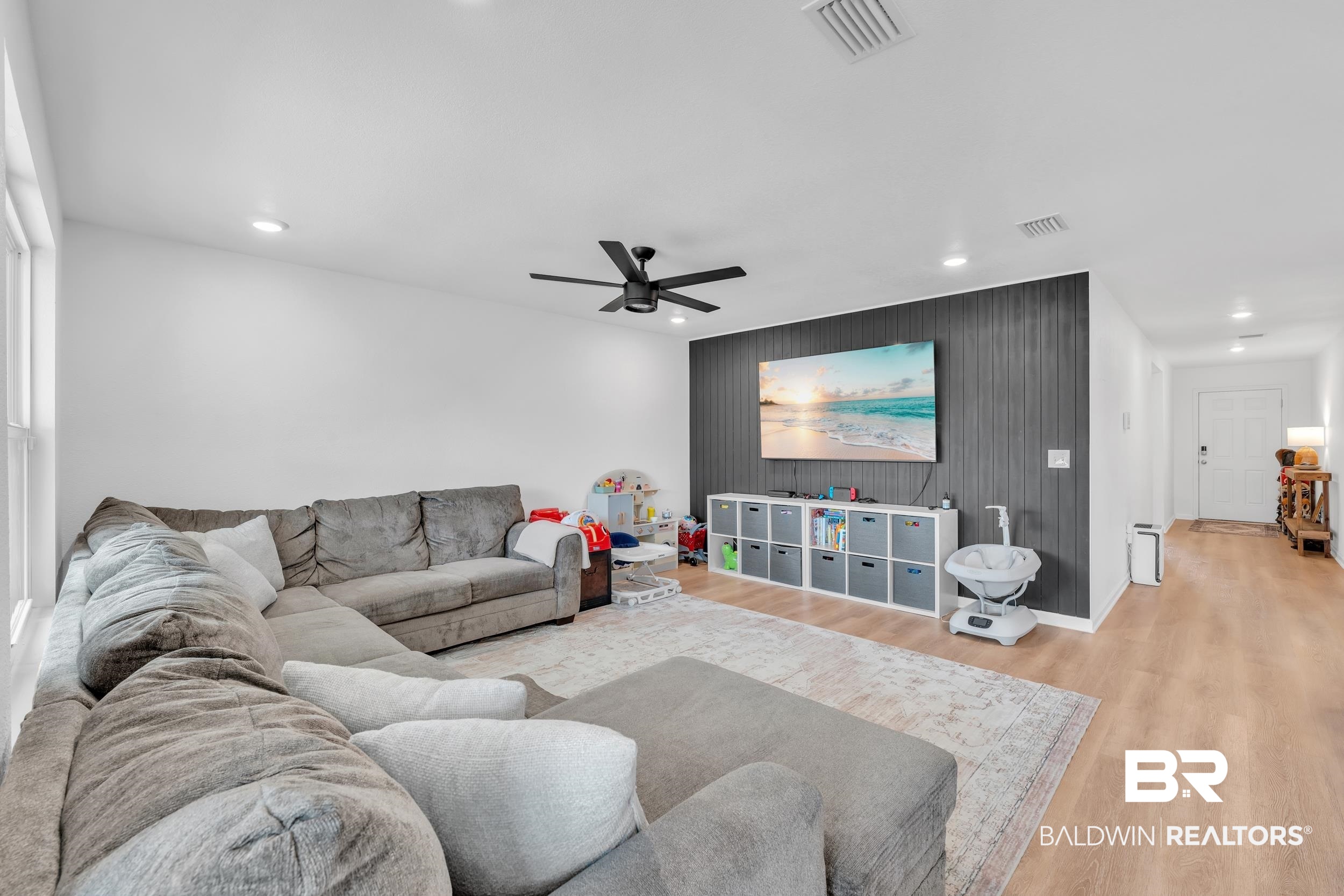8027 Pickwick Dr. Foley, AL 36535 - Photo 17 of 37 Living room featuring a ceiling fan, wood finished floors, recessed lighting, and an accent wall