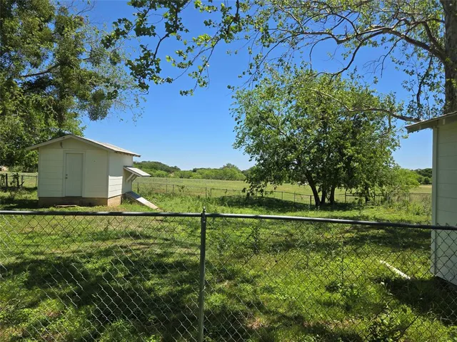 a backyard of a house with lots of green space