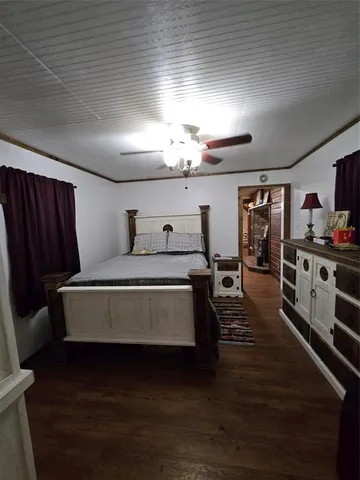 a spacious bedroom with a bed and a chandelier