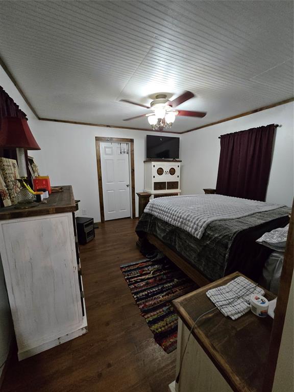 305 South Leon Street Gustine, TX 76455 - Photo 20 of 33 a bedroom with bed and a chandelier