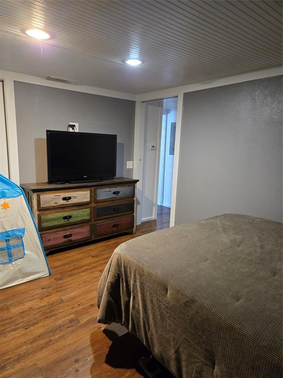 305 South Leon Street Gustine, TX 76455 - Photo 28 of 33 a bedroom with a bed and a flat screen tv