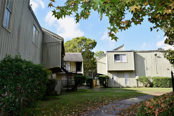 a front view of house with a garden
