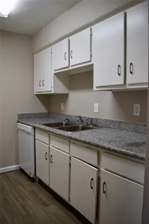a kitchen with granite countertop a sink and cabinets