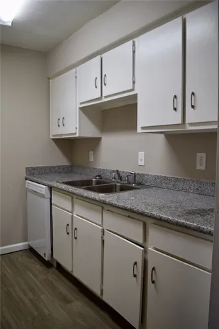 a kitchen with granite countertop a sink and cabinets