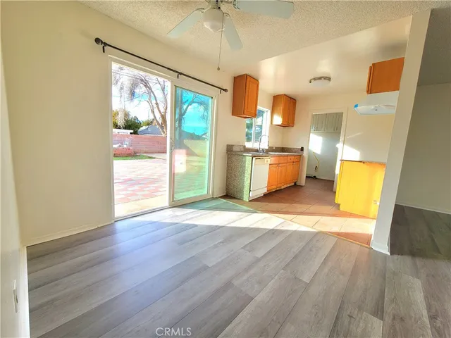 a view of a kitchen with wooden floor and a sink