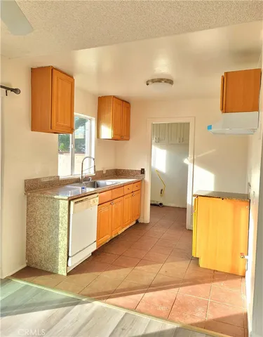 a kitchen with a sink cabinets and a stove