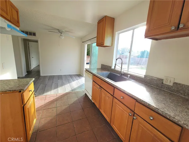 a large kitchen with granite countertop a sink and a counter top space