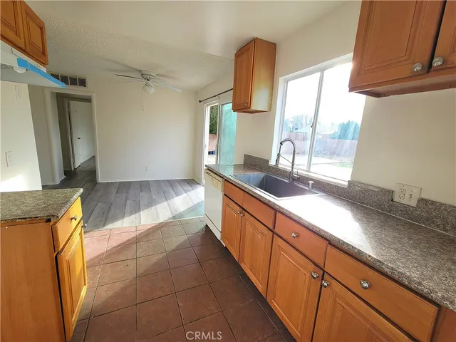 a large kitchen with granite countertop a sink and a counter top space