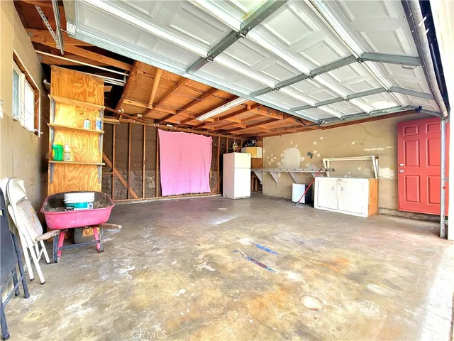 a view of a room with wooden walls and a bed