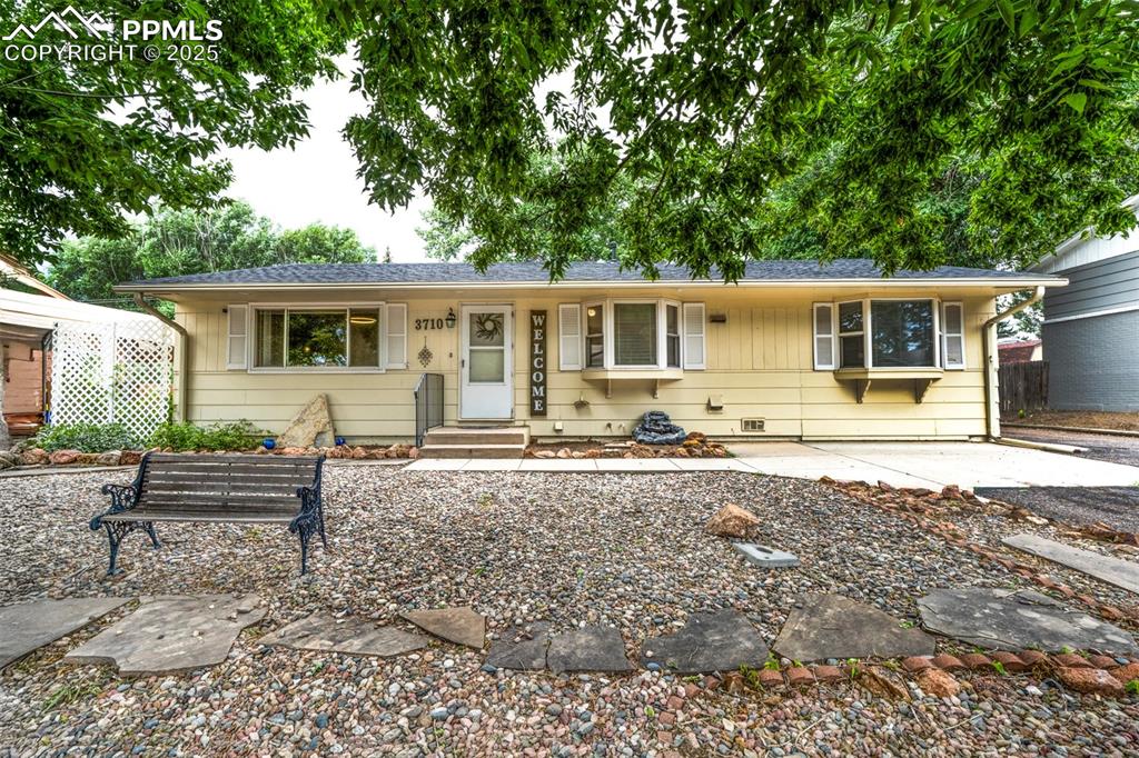 a front view of house with yard patio and outdoor seating