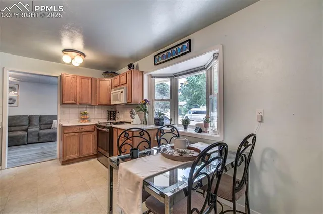 a view of a dining room with furniture window and outside view