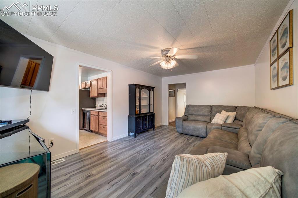 3710 Windflower Circle Colorado Springs, CO 80918 - Photo 13 of 32 a living room with furniture and a wooden floor