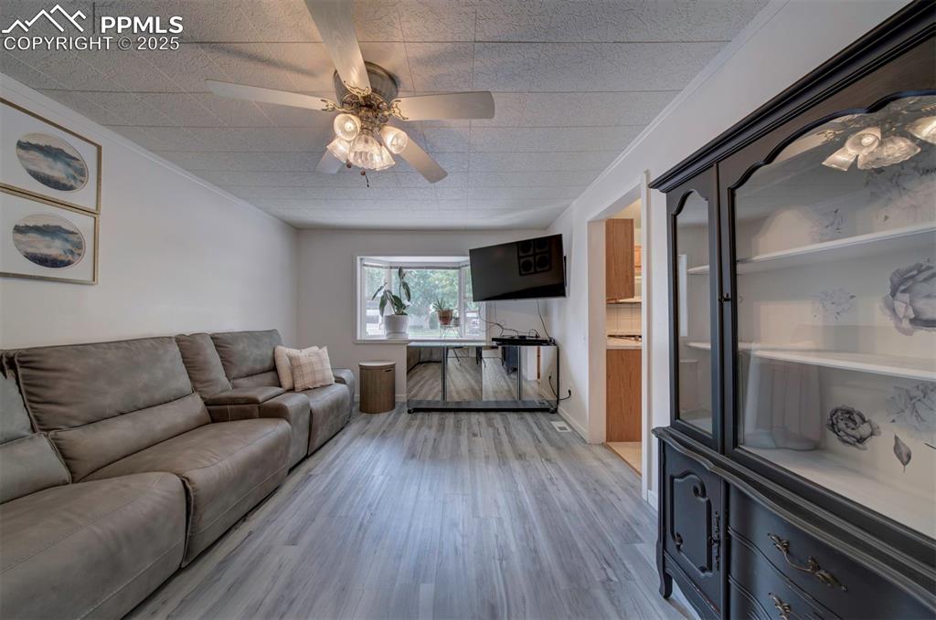 3710 Windflower Circle Colorado Springs, CO 80918 - Photo 14 of 32 a living room with furniture and a flat screen tv