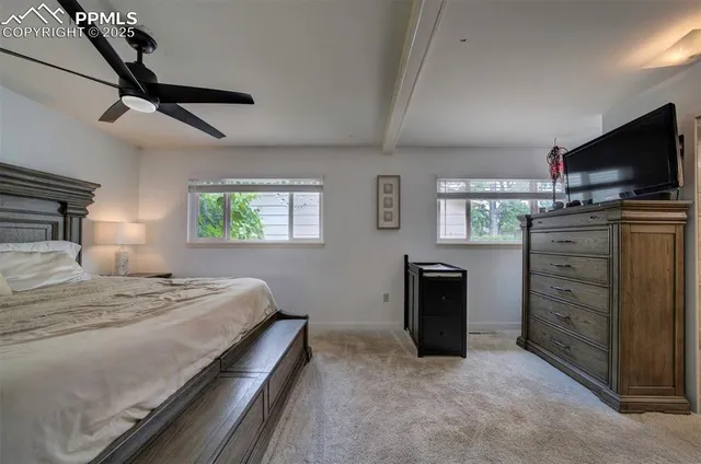 a bedroom with a bed and a television