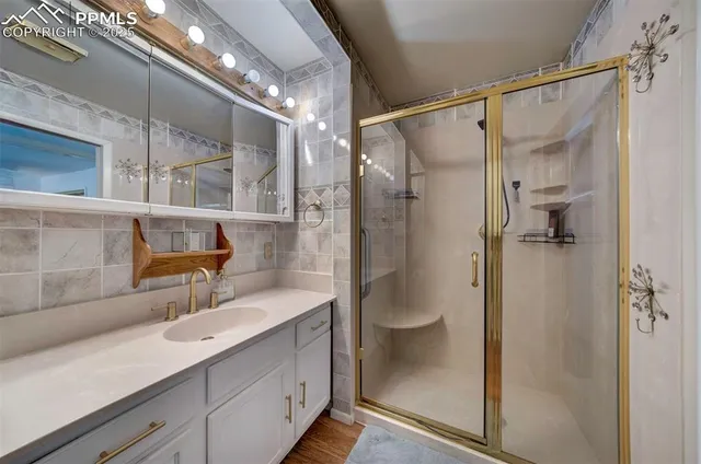 a bathroom with a shower sink and mirror