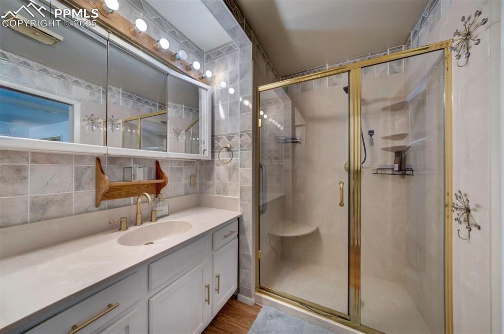 3710 Windflower Circle Colorado Springs, CO 80918 - Photo 19 of 32 a bathroom with a shower sink and mirror