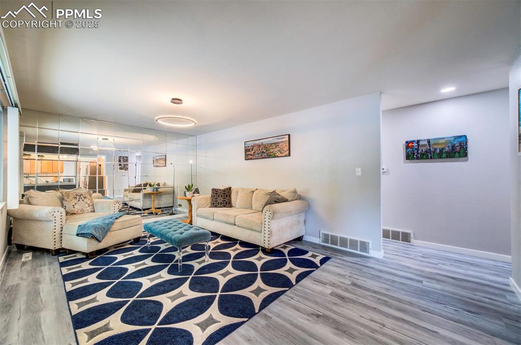 3710 Windflower Circle Colorado Springs, CO 80918 - Photo 6 of 32 a living room with furniture and a wooden floor