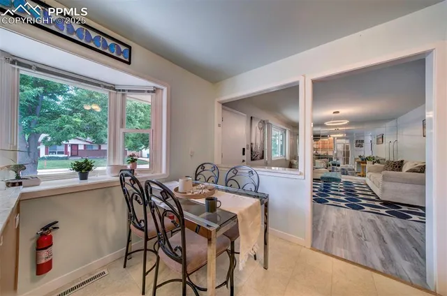 a view of a dining hall with furniture and windows