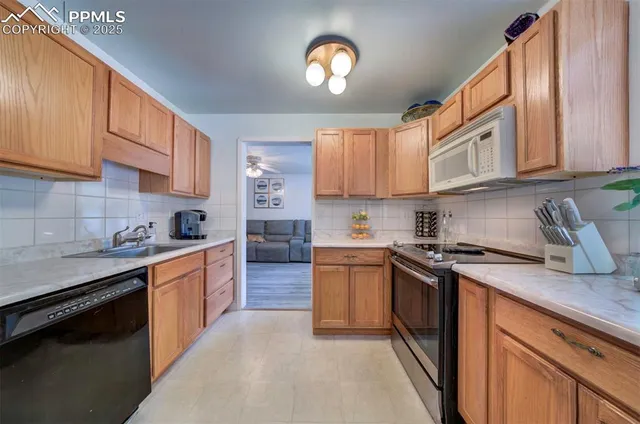a kitchen with stainless steel appliances granite countertop a stove sink and cabinets