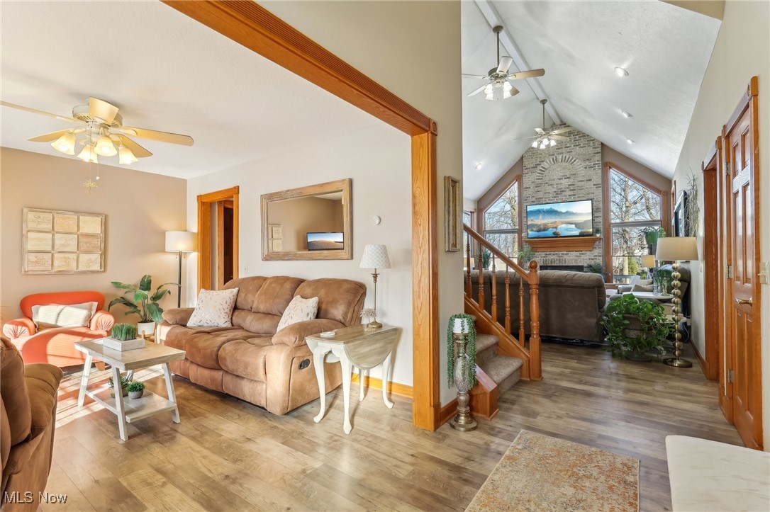 3353 Jens Way Perry, OH 44081 - Photo 6 of 49 Living room with hardwood / wood-style flooring, vaulted ceiling, ceiling fan, and a fireplace