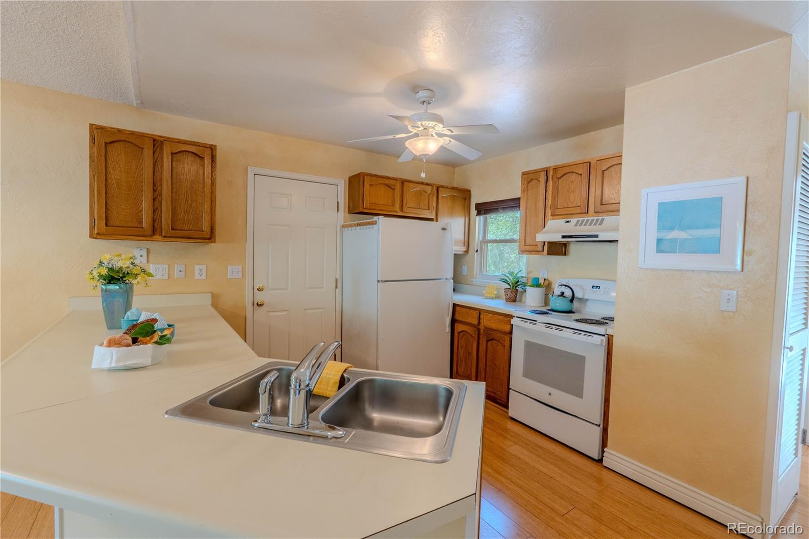 961 Columbine Avenue Colorado Springs, CO 80904 - Photo 14 of 47 a kitchen with stainless steel appliances granite countertop a sink stove and refrigerator