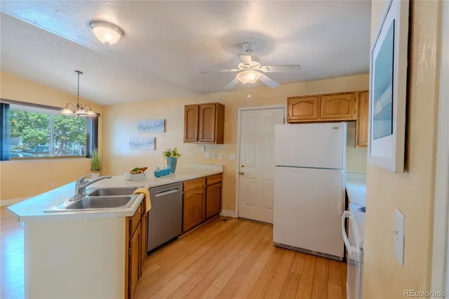a room with a sink wooden floor and furniture