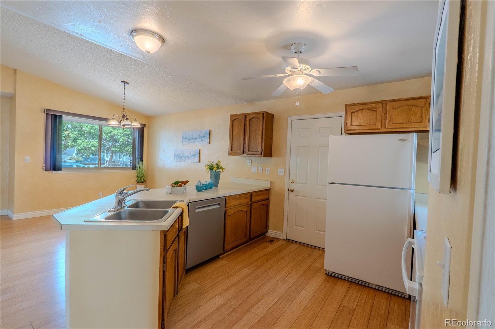 961 Columbine Avenue Colorado Springs, CO 80904 - Photo 17 of 47 a kitchen with sink refrigerator and microwave