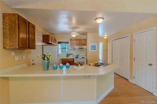 a kitchen with a sink a stove and cabinets