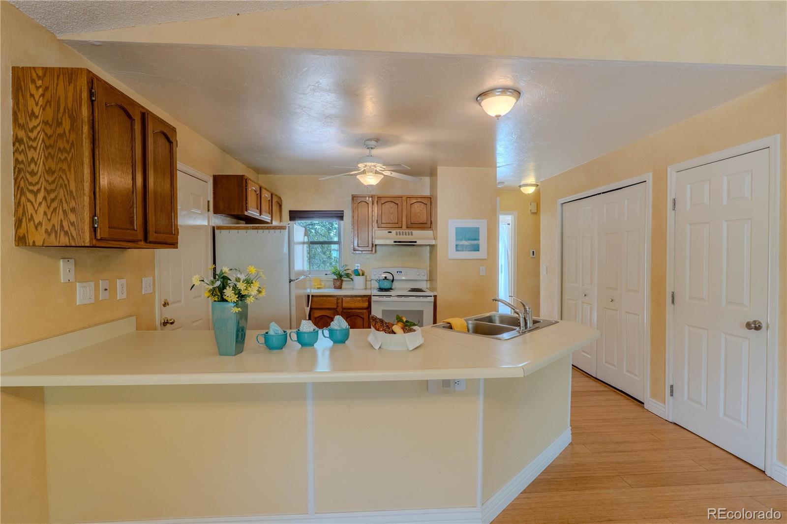961 Columbine Avenue Colorado Springs, CO 80904 - Photo 19 of 47 a kitchen with a sink a stove and cabinets