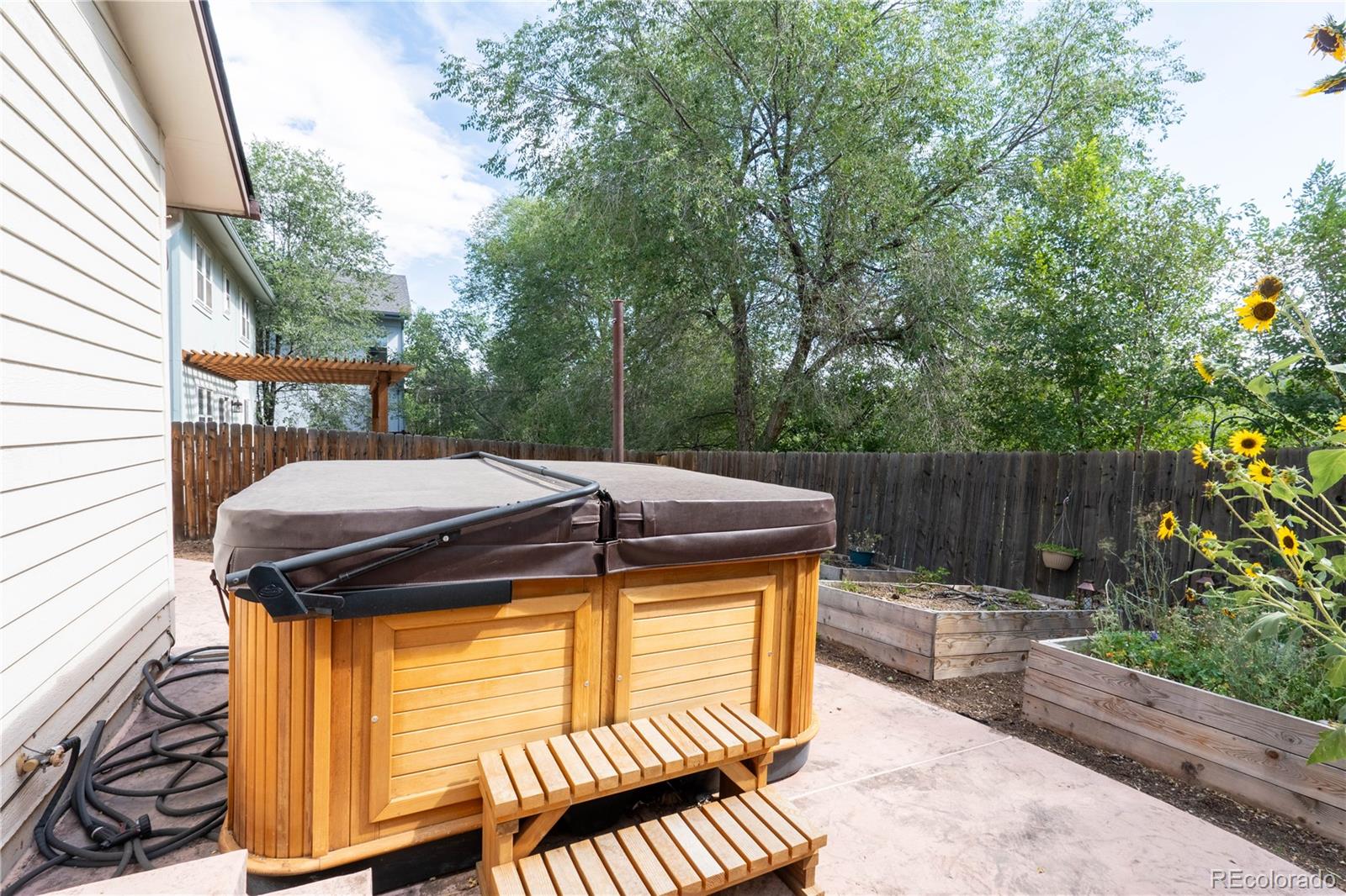 961 Columbine Avenue Colorado Springs, CO 80904 - Photo 25 of 47 a view of a patio with table and chairs with wooden floor and fence