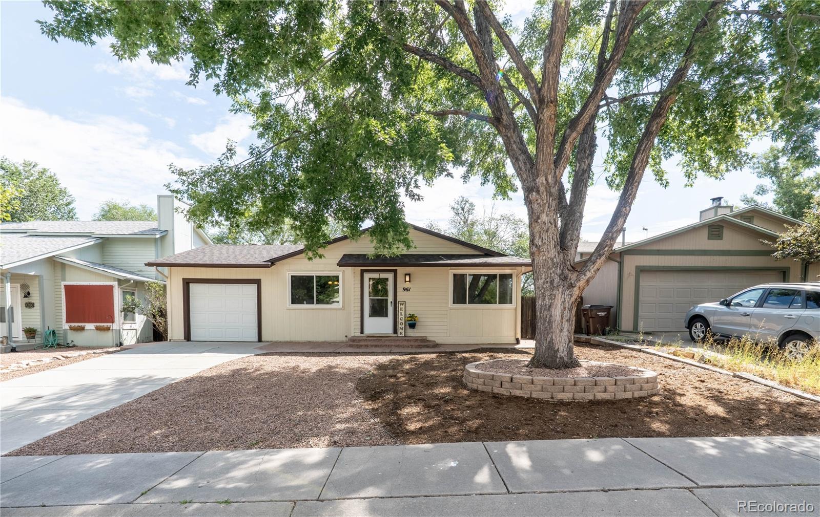 961 Columbine Avenue Colorado Springs, CO 80904 - Photo 3 of 47 a front view of a house with a yard