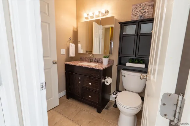 a bathroom with a toilet a sink and a mirror