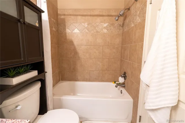 a bathroom with a bathtub and shower