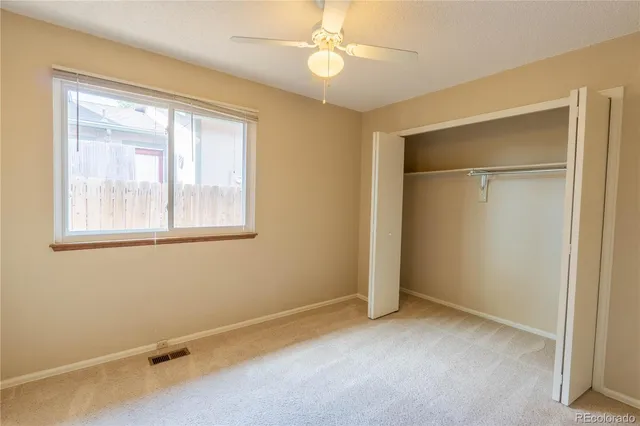 an empty room with windows and closet