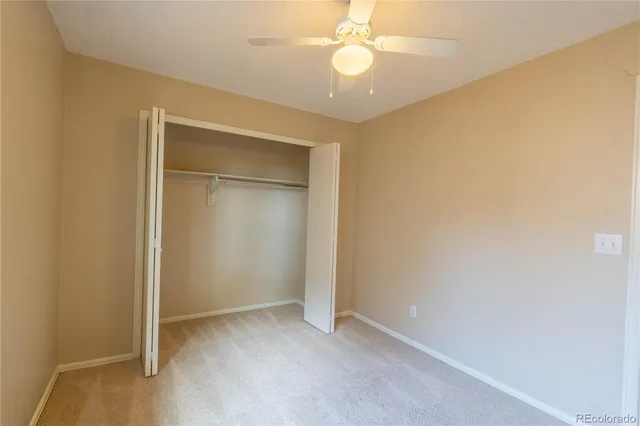 an empty room with a empty space and a ceiling fan